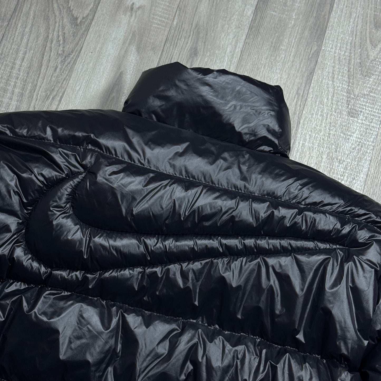 NIKE NOCTA GLOSSY PUFFER JACKET BLACK